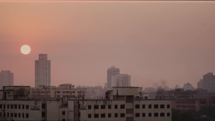 The sun over a city