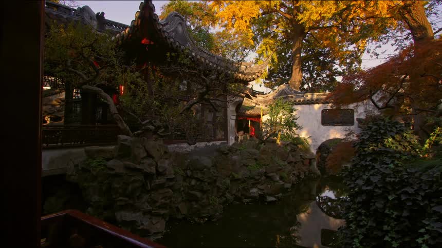 An asian garden area lies in the middle of several buildings