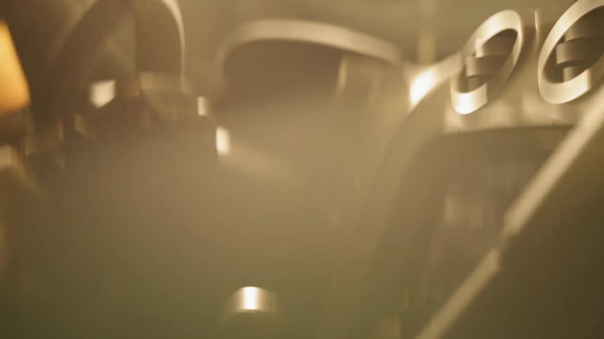 A gloved driver shifts gears while operating a vehicle