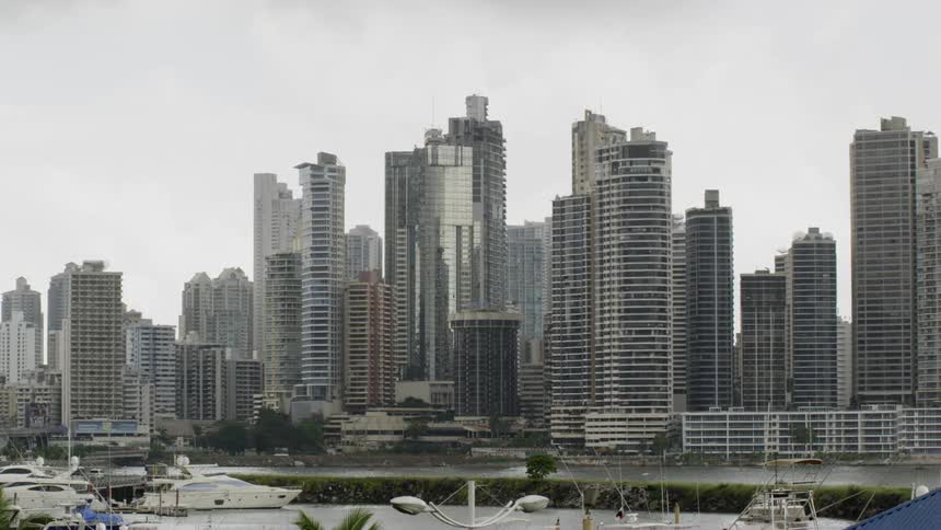 A marina with boats with the city skyline in the background