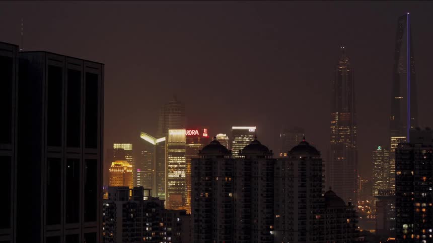Lights on city skyscrapers flash and blink at night