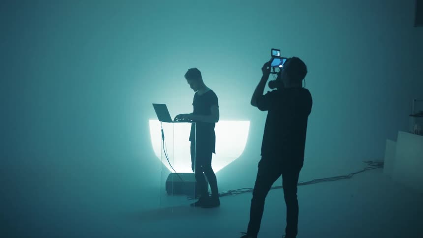 Cameraman records dj performing from laptop