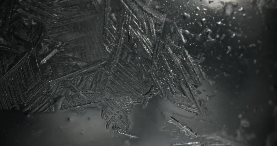 Ice crystals forming on a wet transparent surface