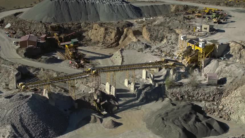 A large mine is filled with large construction type mining equipment