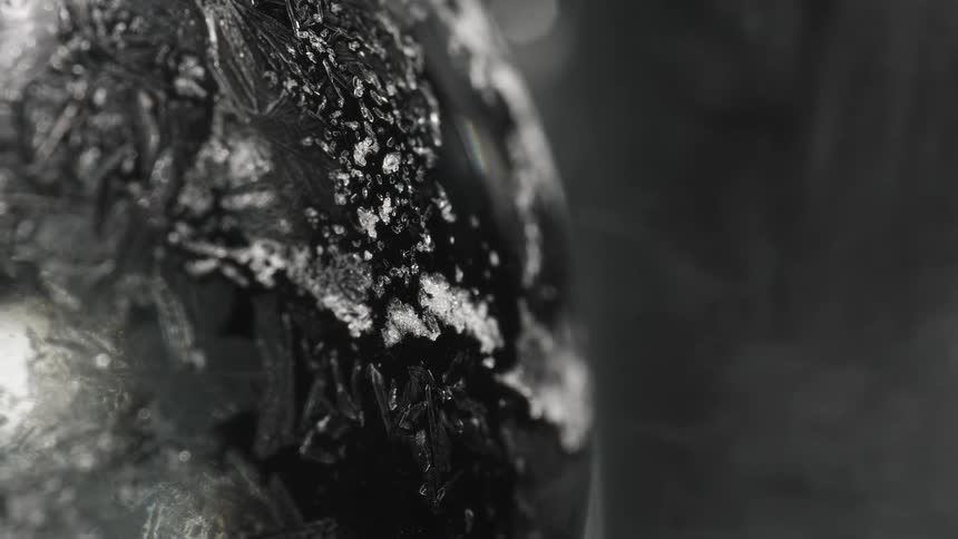 Frost crystals forming on black surface
