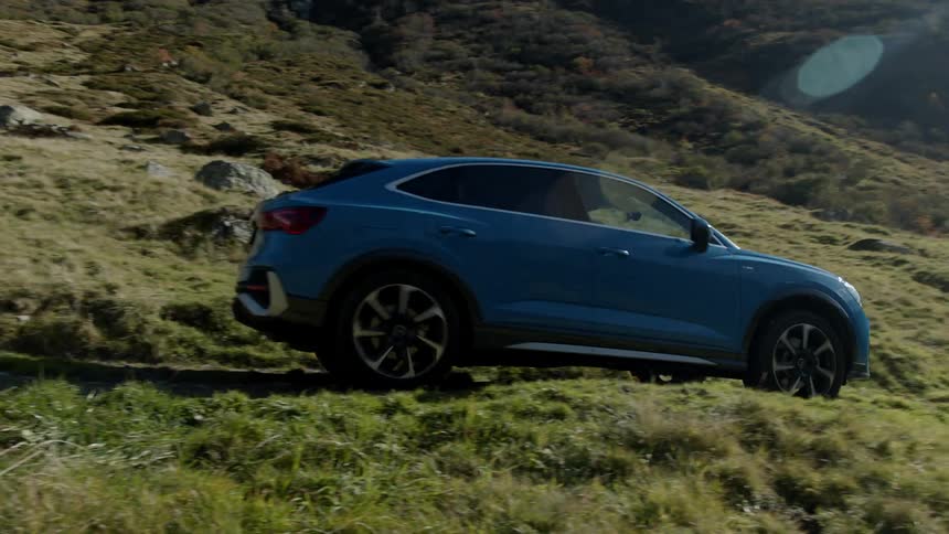 A car drives through a mountainous area