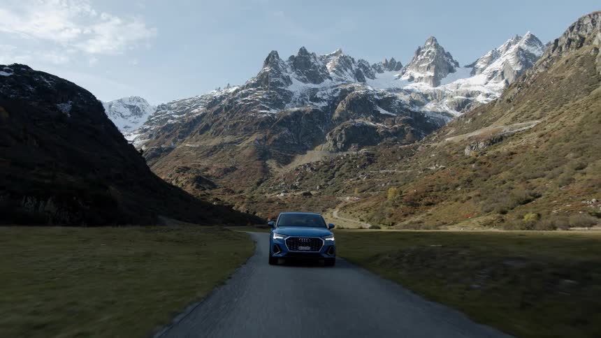 A car drives through the mountains