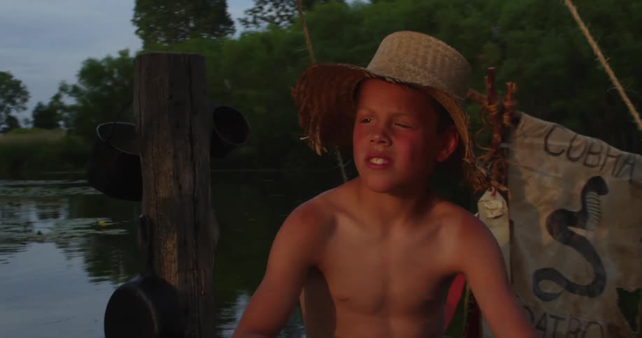A boy sits on a raft