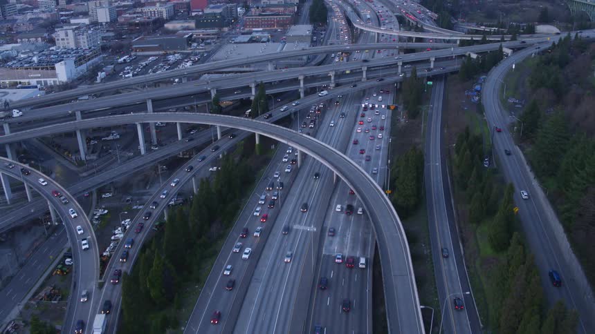 City traffic slowly flows along a complex maze of ramps and highways