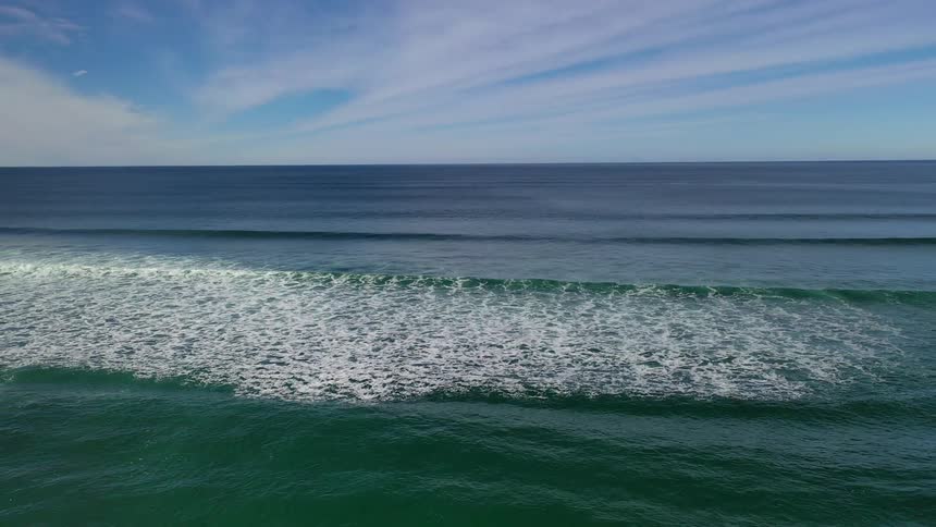 Whitecapped waves roll in the ocean