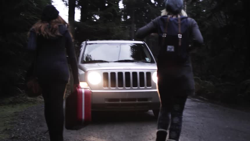Two women preparing to get inside a vehicle