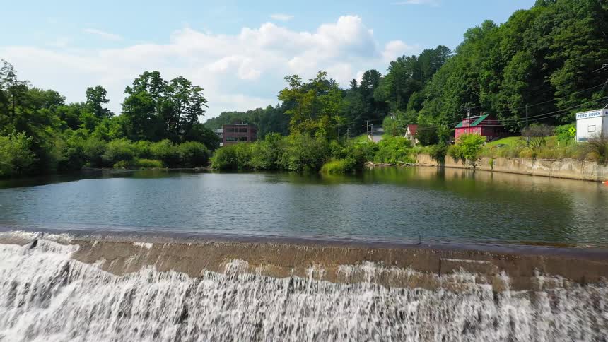A river surrounded by trees is displayed