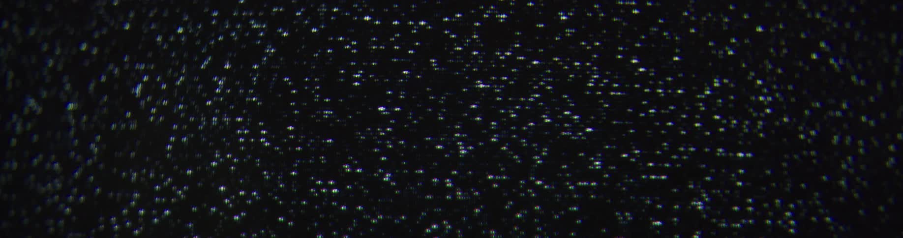 Black white and gray colors that look like snow on a television screen