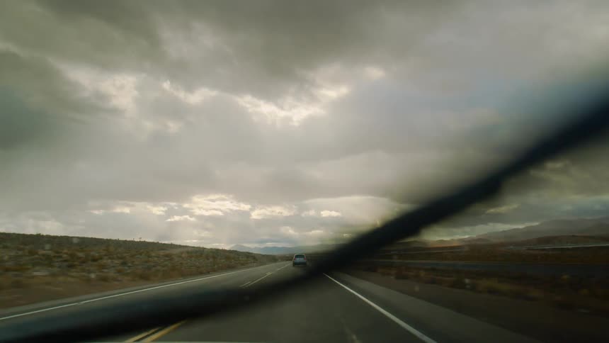 Driving on a country road while raining with the windshield wipers on