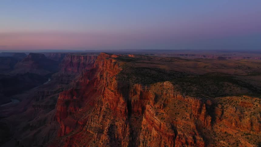 Vegetation grows on the sides of a steep and deep canyon