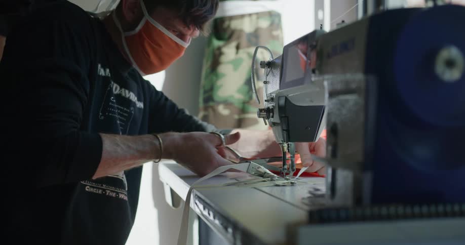 The worker cuts the fabric