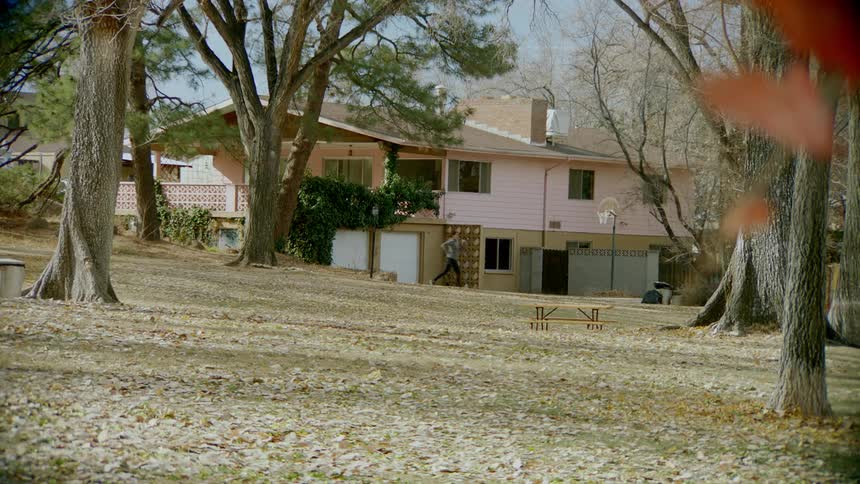 Child runs through backyard of home