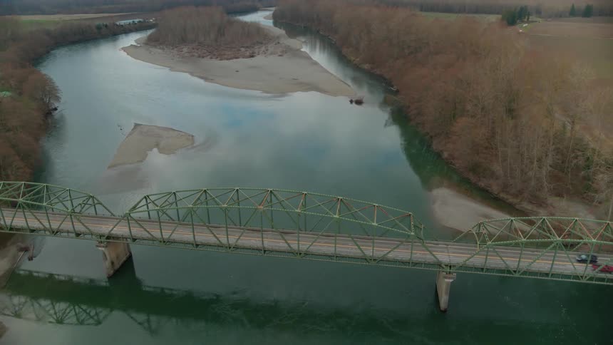 Light traffic on old rural bridge over river