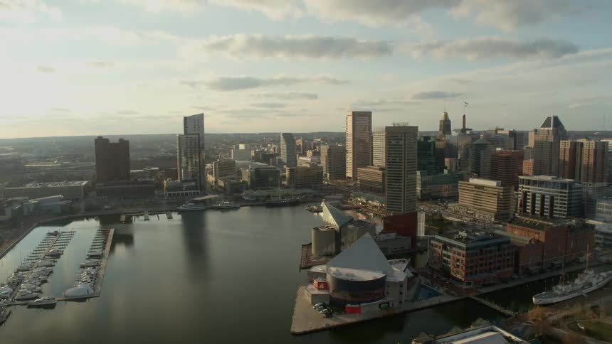 A downtown part of a large city sits next to a harbor