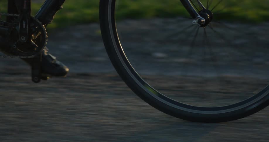 A person is riding a bicycle down a trail