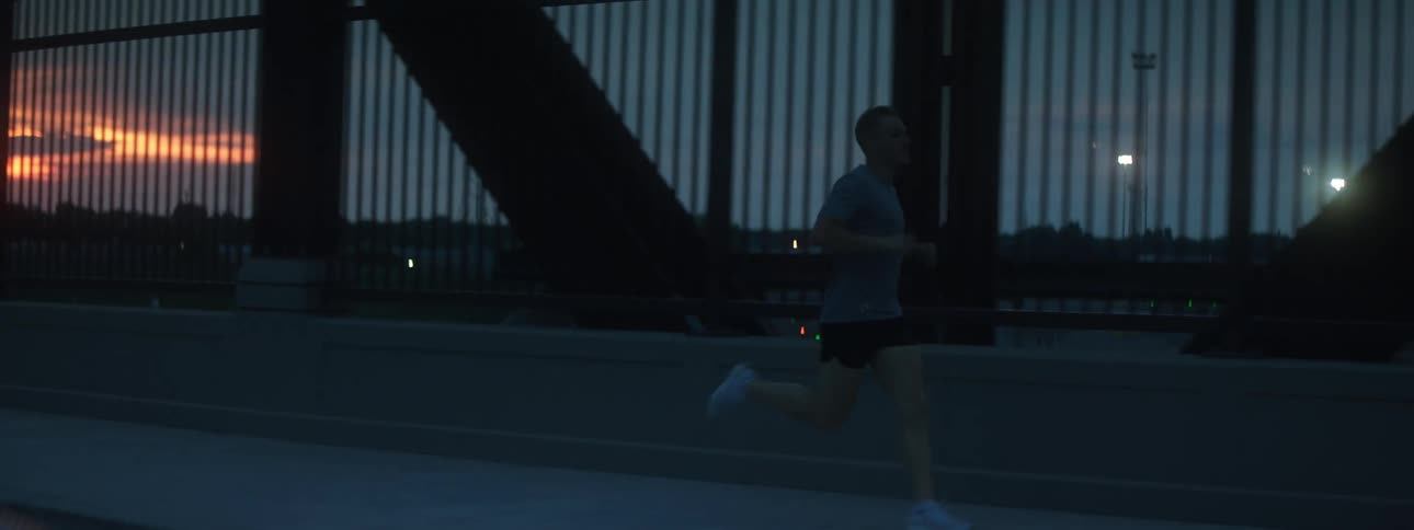A man runs across a bridge