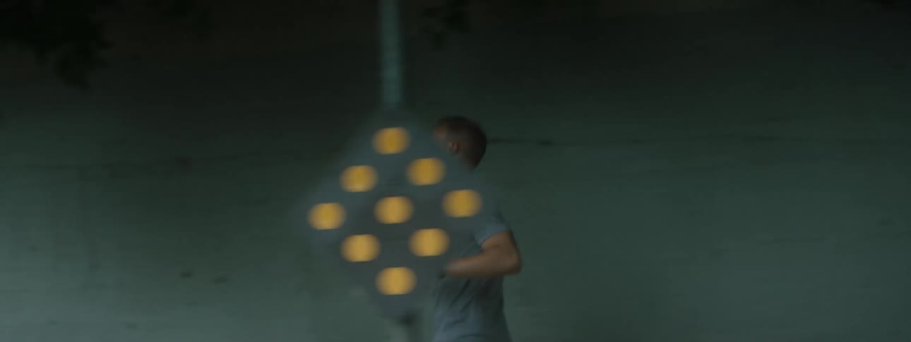 A man running on a sidewalk with trees in the background