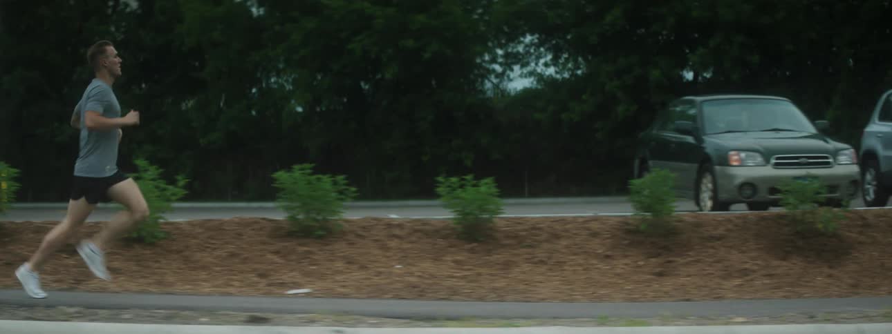 A man runs down a street for exercise