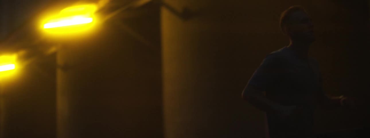 A man is running outside at night