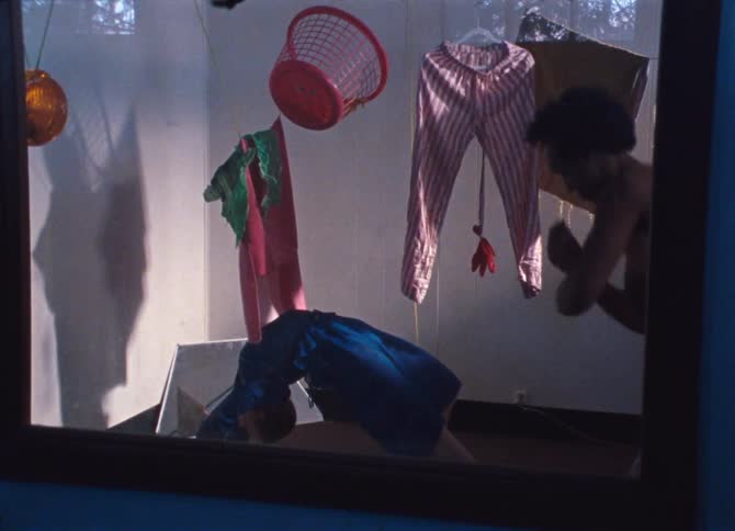 A man dances in the window