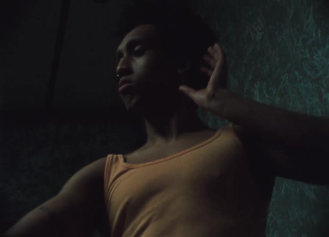 A black man dances inside