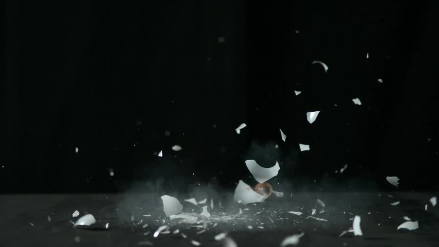 Light bulb falls onto a surface and breaks