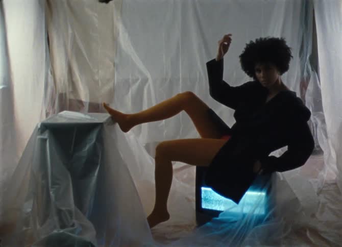 A model poses on a broken television