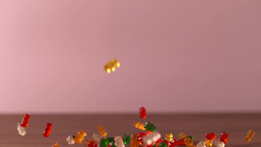 Gummy bears falling to a counter in a studio