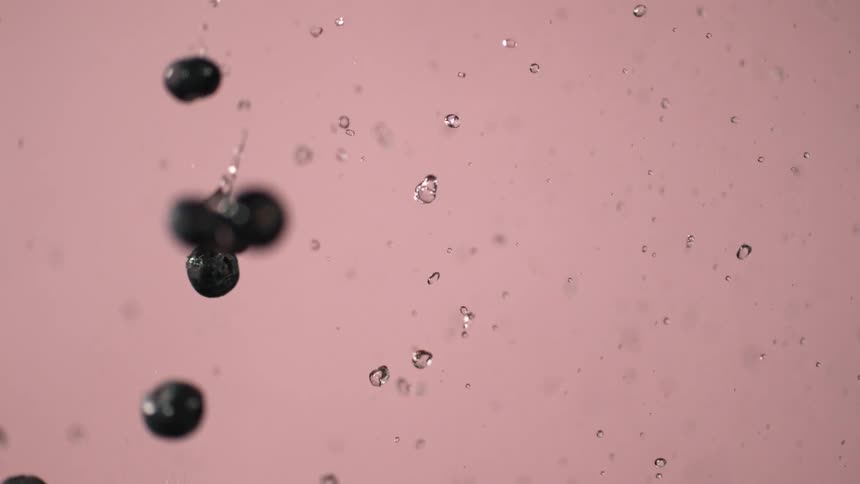 Blueberries being splashed as they fall in water