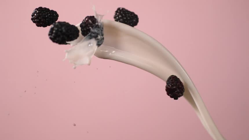 A splash of milk and berries collide in mid air