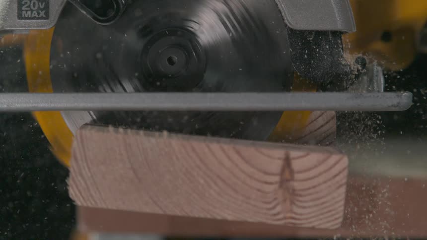 Saw cutting through piece of lumber