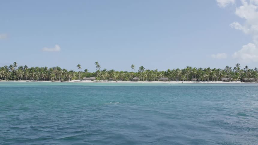 The ocean with a sandy shore in the background