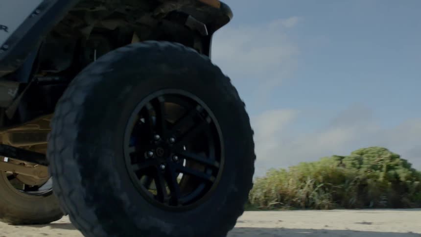 A jeep traveling along a dirt path in the countryside