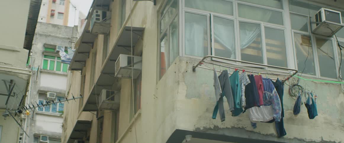 Clothing blowing in the wind hanged up in front of a building