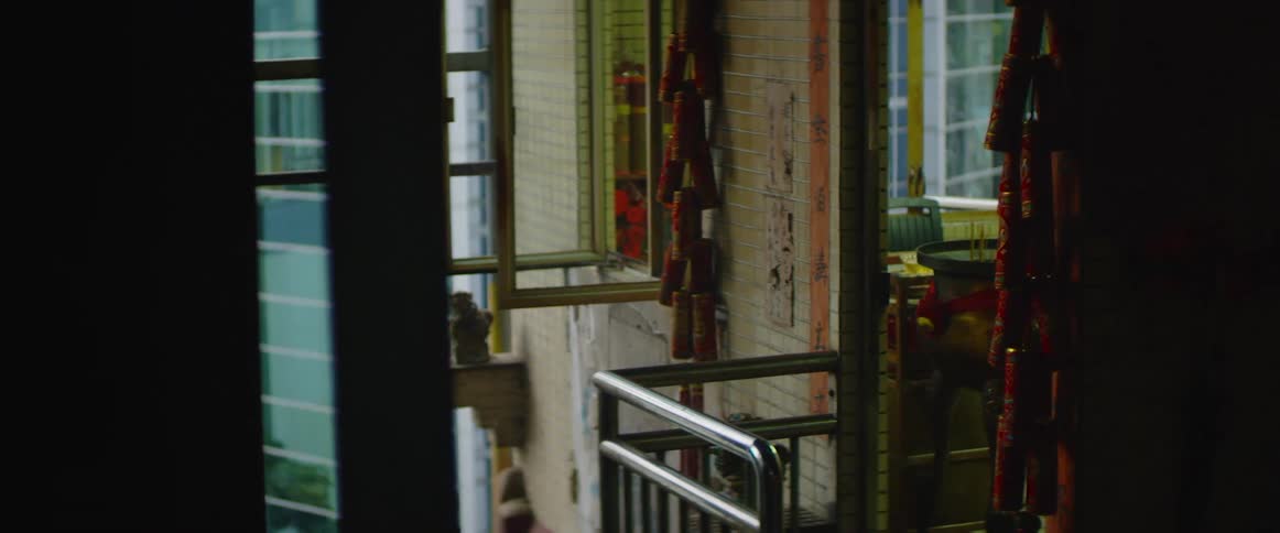 An interior space has open windows and items hanging on the wall