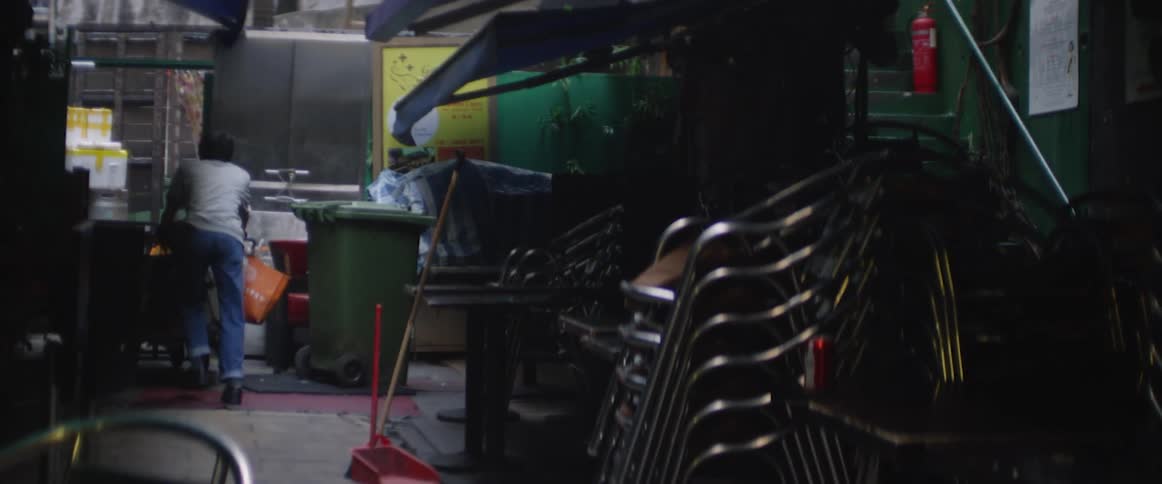 Two men work in a cluttered business