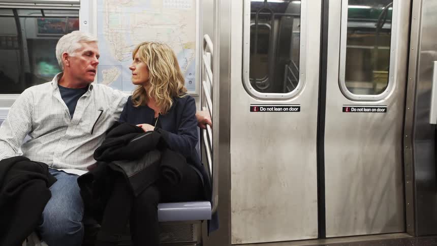 Couple talks while sitting on metro train seat
