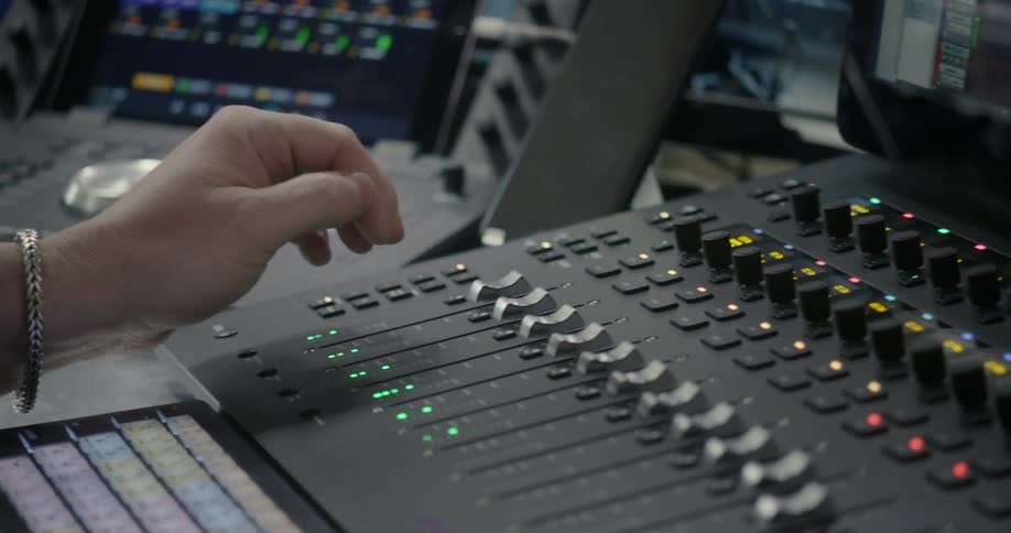 Hands using audio mixing equipment
