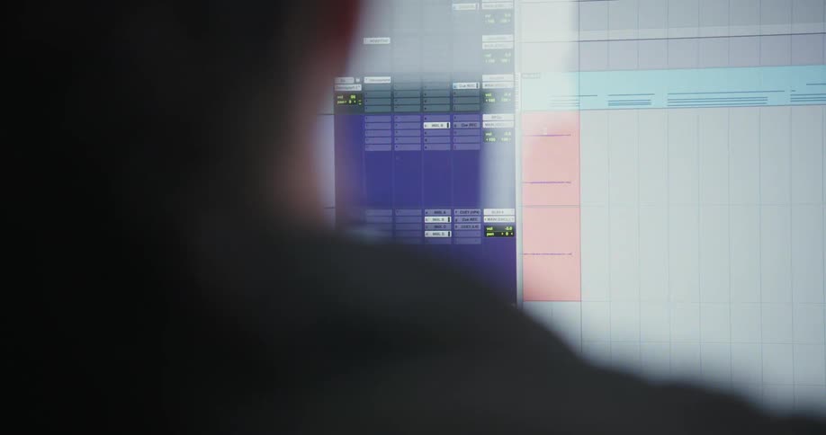 A person sitting in front of a computer using an audio editor application