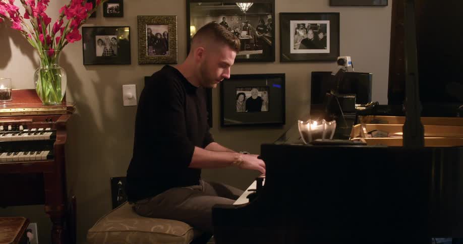 A young man playing the piano