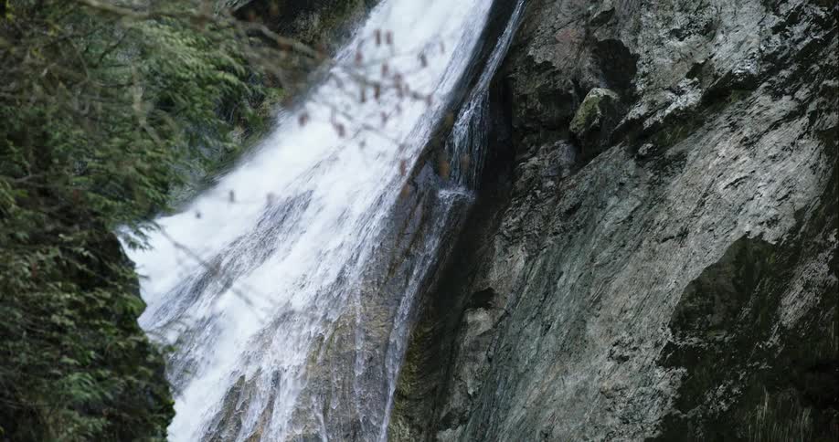 Small waterfall cascades down rock face