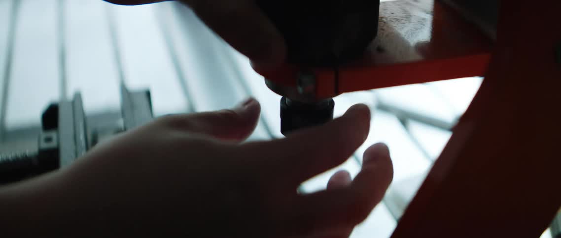 A wrench is used to remove a drill head from a tool