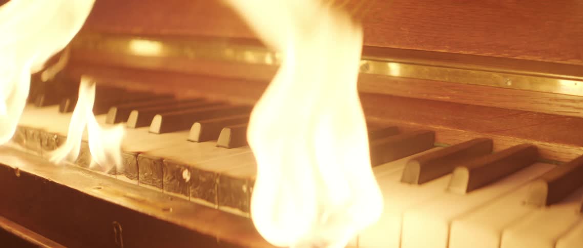 The keys of a piano are on fire