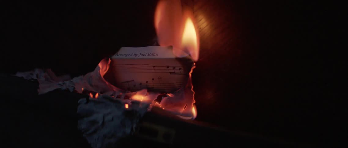 Sheet music burning in the dark