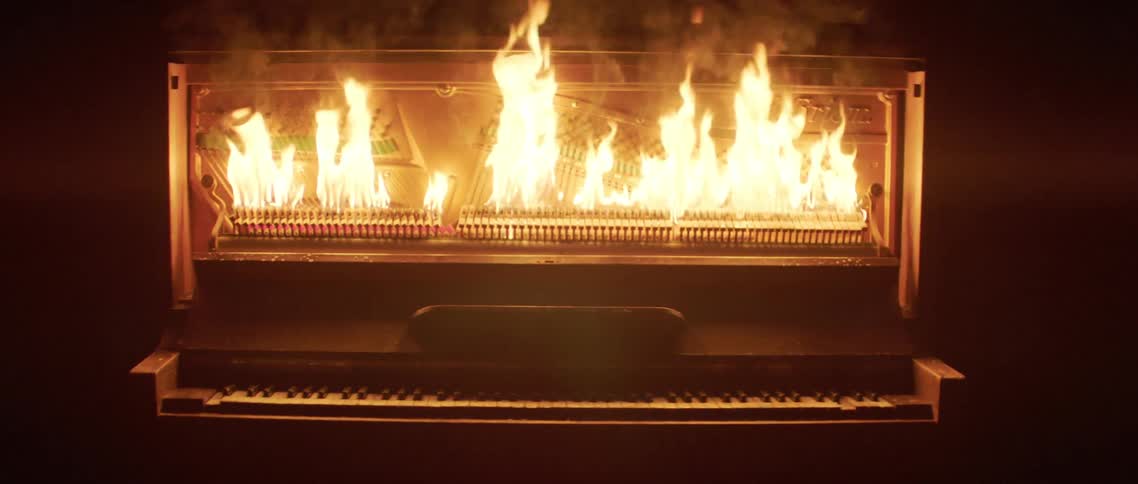 A piano engulfed in flames